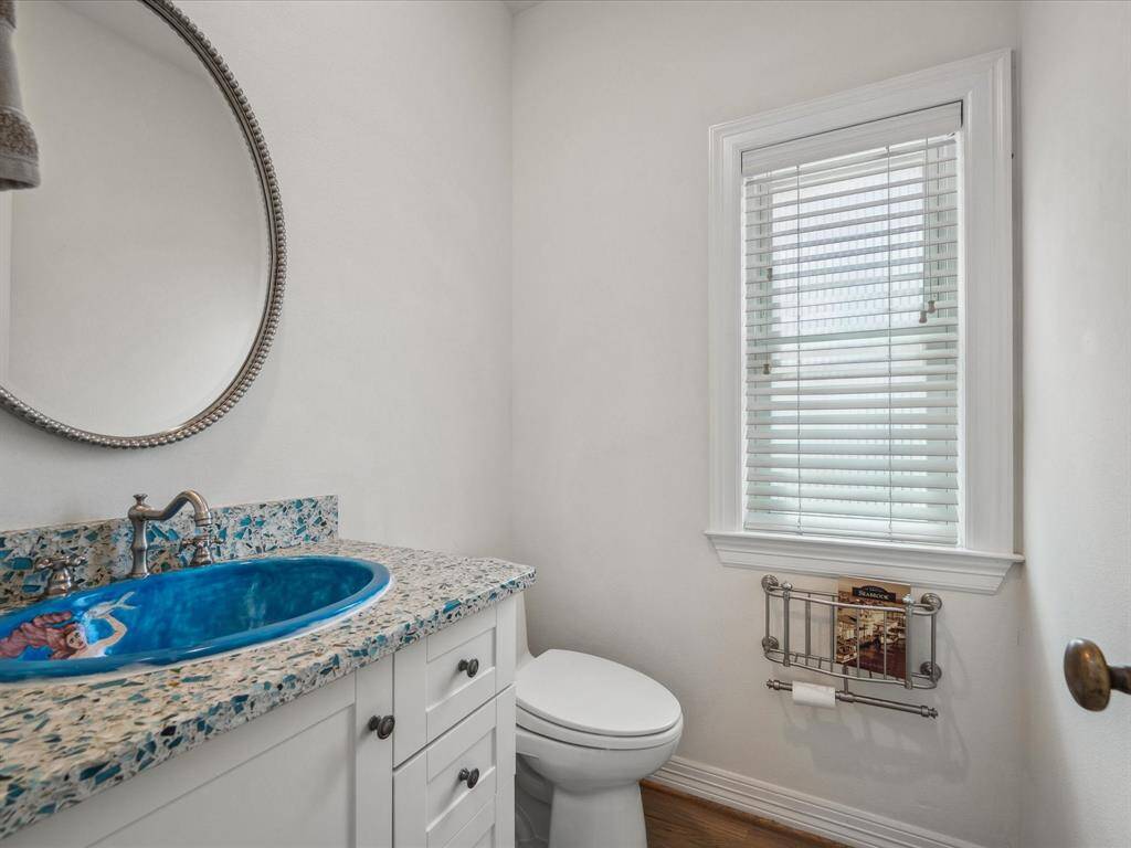 FIRST LEVEL HALF BATH WITH TROPICAL, HAND-PAINTED SINK.