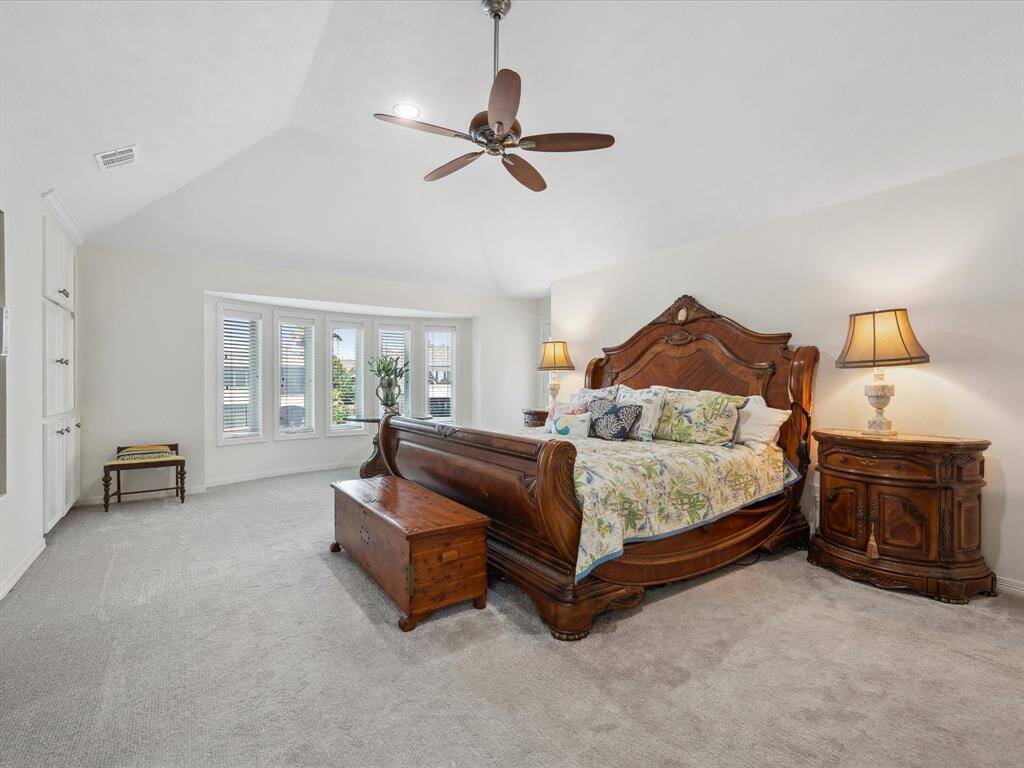 LARGE PRIMARY SUITE WITH GAMBREL CEILINGS AND BUILT-INS.
