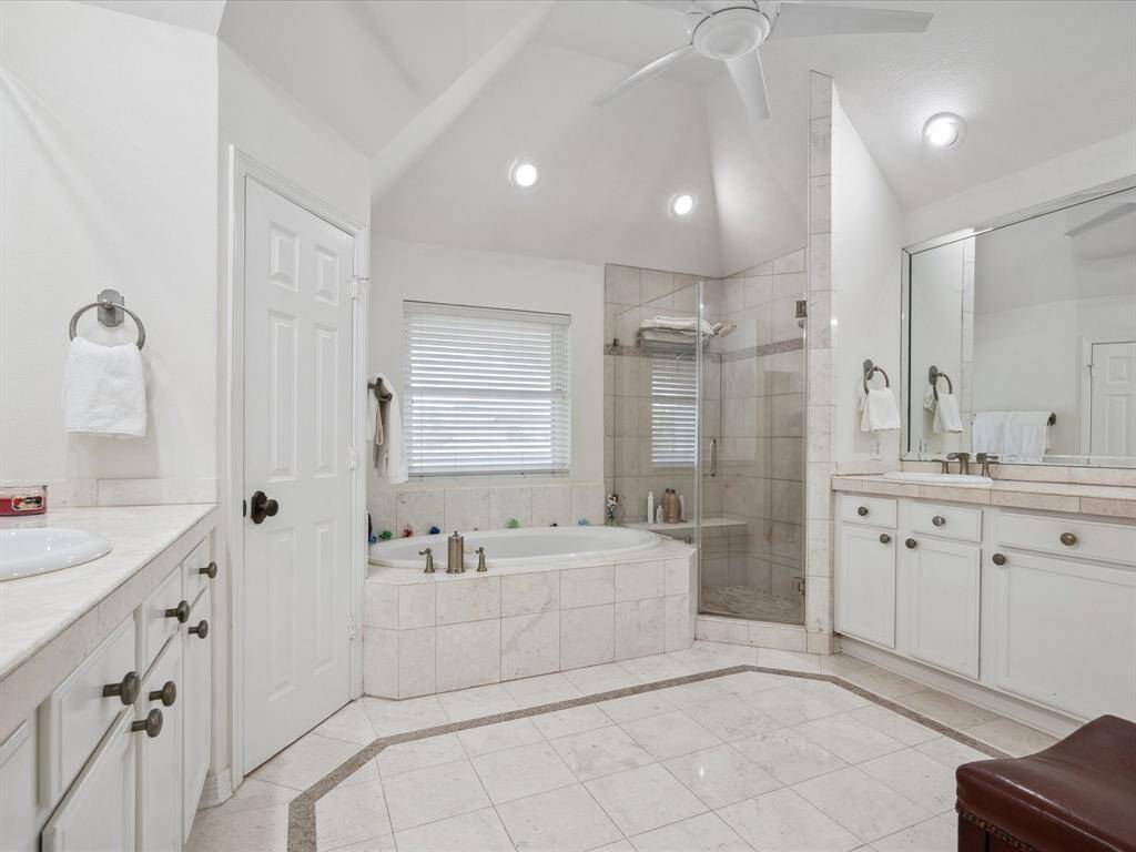 NICELY FINISHED PRIMARY BATH WITH HIS AND HER VANITIES AND BEAUTIFUL GAMBREL CEILING.
