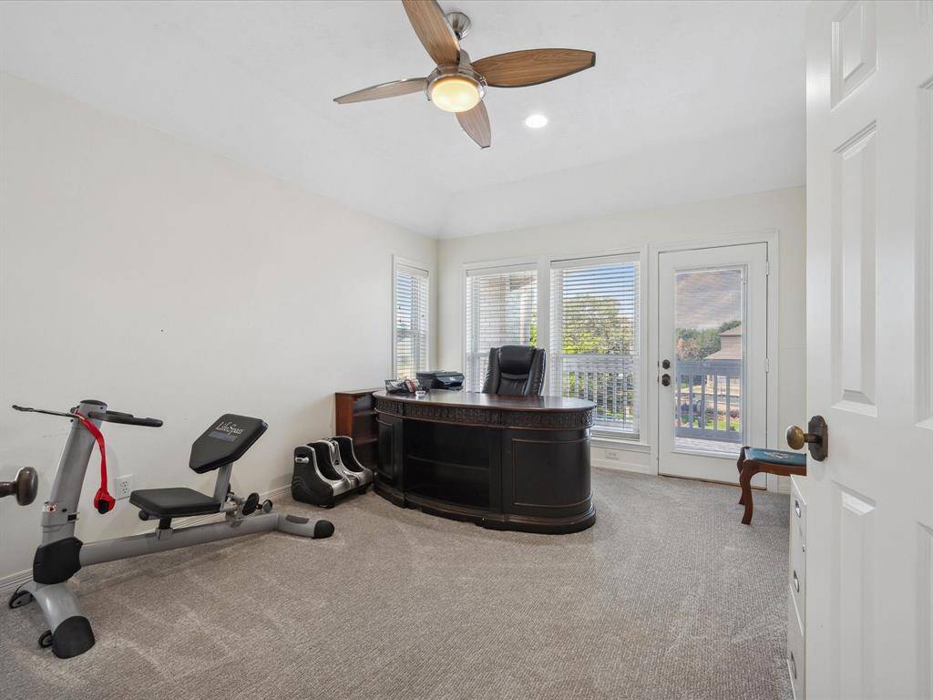 SECOND BEDROOM UPSTAIRS, CURRENTLY USED AS AN OFFICE, ALSO FEATURES A PRIVATE BALCONY.