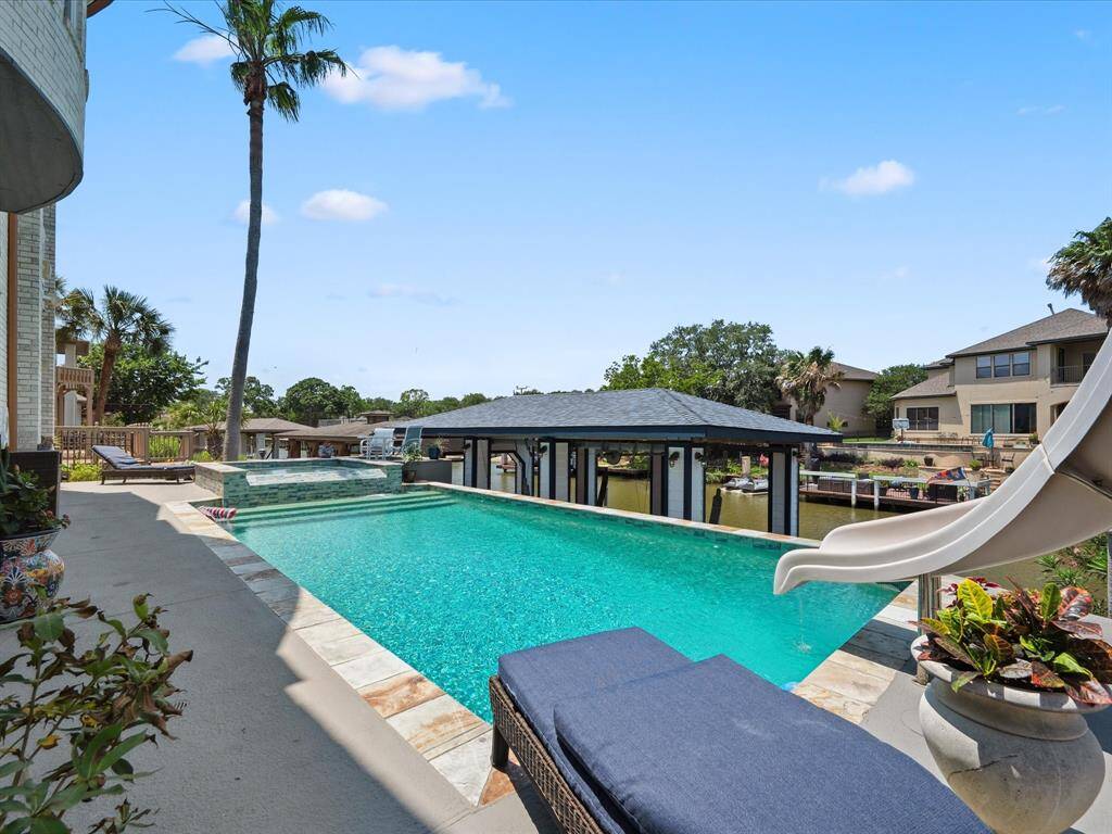 THE OUTSIDE IS READY FOR THE SUMMER COMPLETE WITH POOL, SPA AND WATERSLIDE.