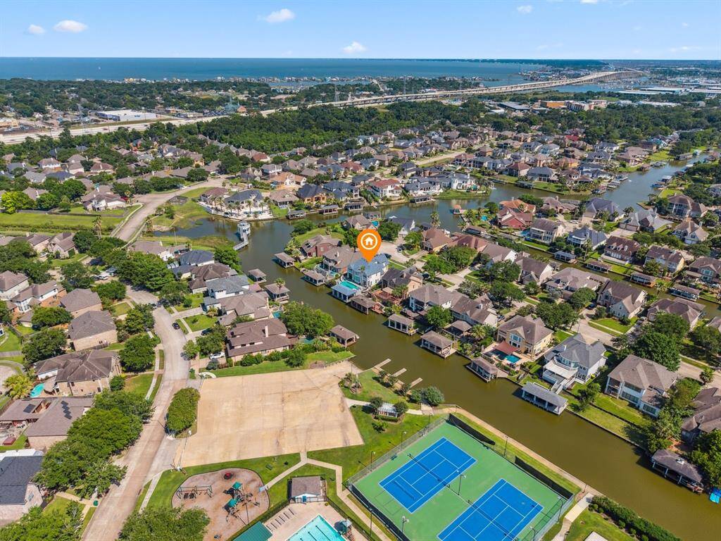 AERIAL VIEW ALSO HIGHLIGHTS THE EXTENSIVE NEIGHBORHOOD AMENITIES ACROSS THE CANAL INCLUDING THE BOAT RAMP, TENNIS COURTS, VOLLEYBALL COURTS AND MORE.