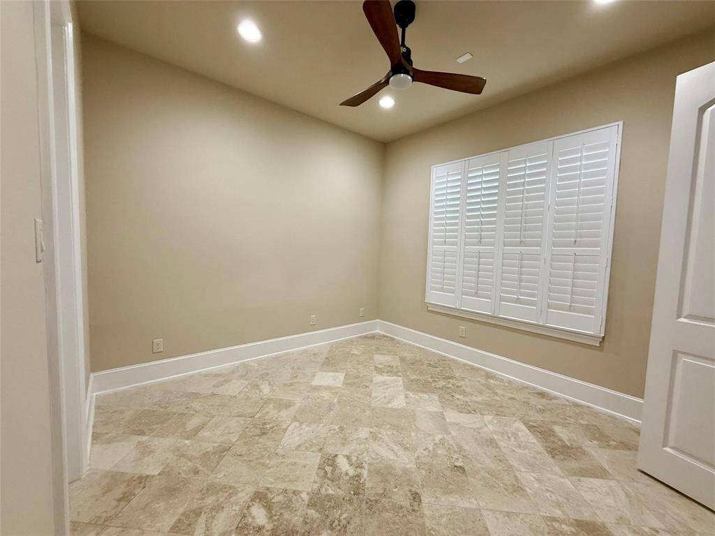 Extra 2nd bedroom down with nice plantation shutters, ceiling fan with its own full bath, it can be a mother-in-law suite or exercise room or hubby room.
