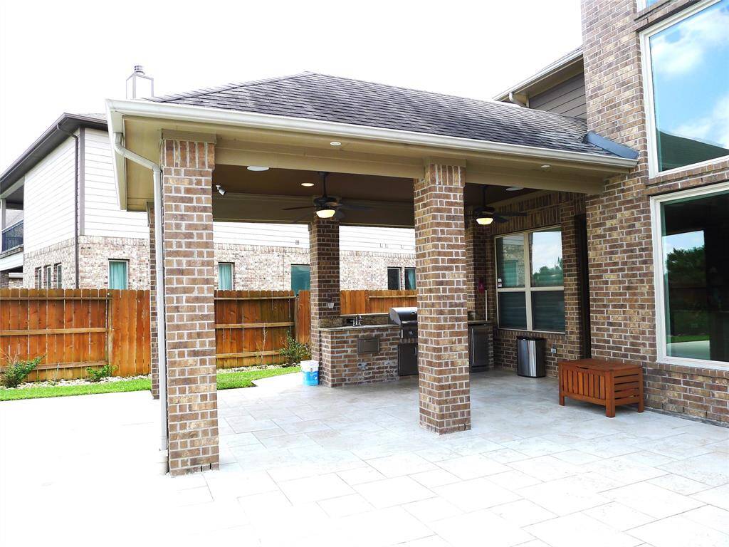 Look out this covered patio and outdoor kitchen.