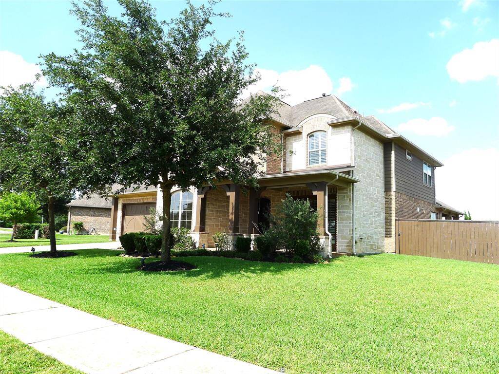 Beautiful stove/brick elevation with front porch, double wide driveway in a large lot, with Lush landscaping.