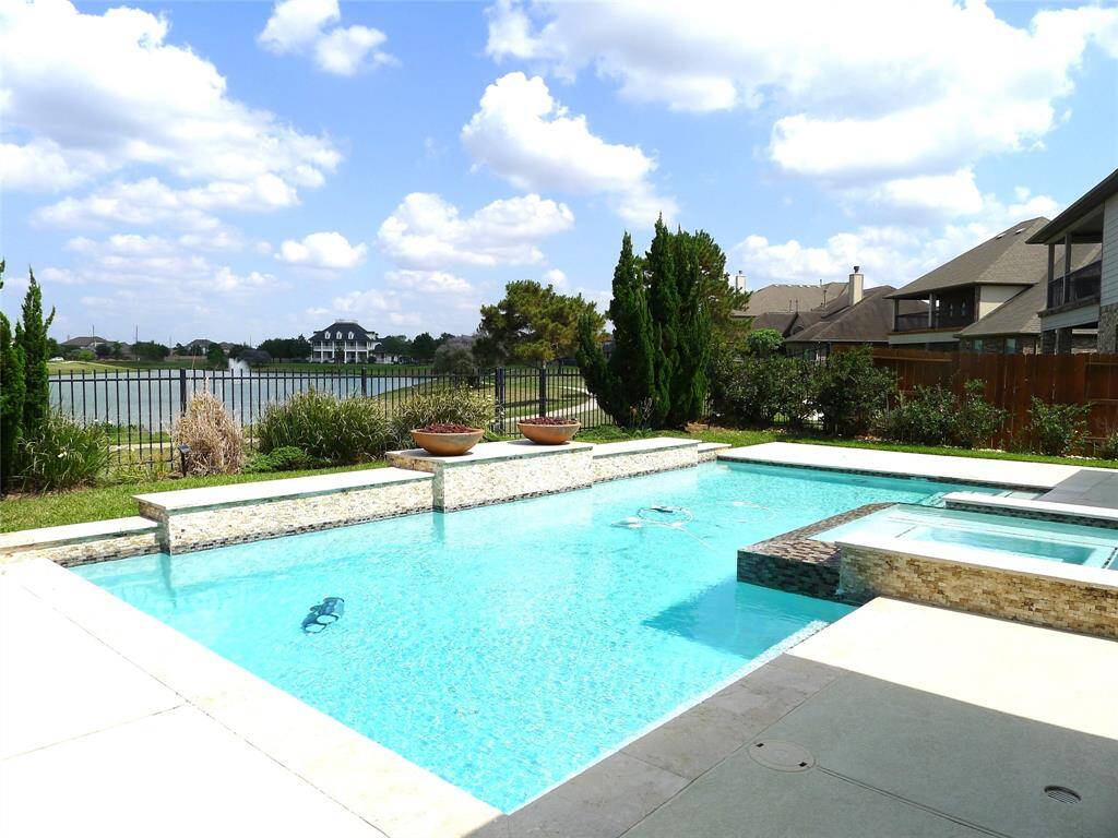 Additional marvelous view of the backyard with the pool and lake view