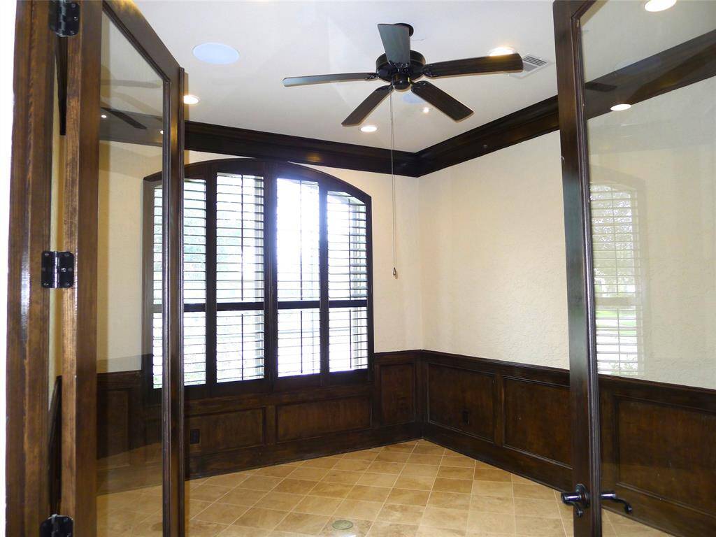 Great home office offers double full view doors, crowning molding, shutters.