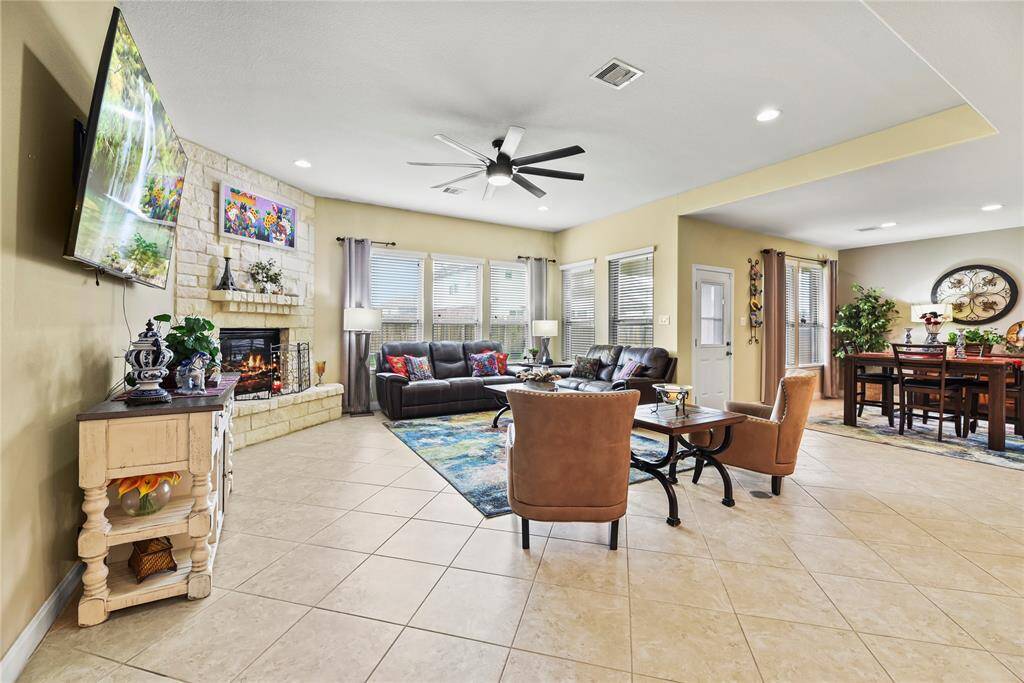 Step into the stunning living space, where a coffered ceiling adds architectural elegance and depth. A dramatic wall of windows floods the room with natural light, creating a bright and airy ambiance.