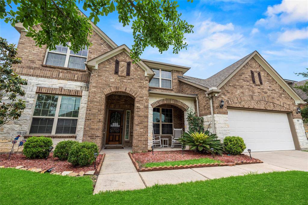 The brick and stone exterior exudes charm and elegance, creating exceptional street appeal that captivates at first glance.