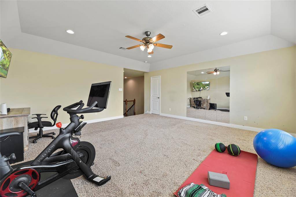 Step up to the spacious game room, an ideal retreat for play, relaxation, or entertainment. Perfect for keeping toys, games, and activities tucked away upstairs, this versatile space offers plenty of room to unwind while maintaining a sense of organization and ease throughout the home.