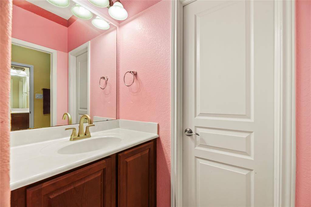 The Hollywood-style bath boasts separate vanities, providing both functionality and privacy.