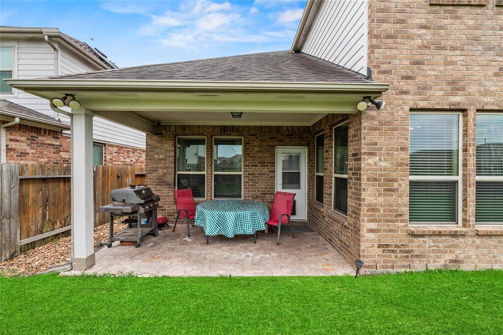 Covered patio provides an area to relax and enjoy the large backyard.