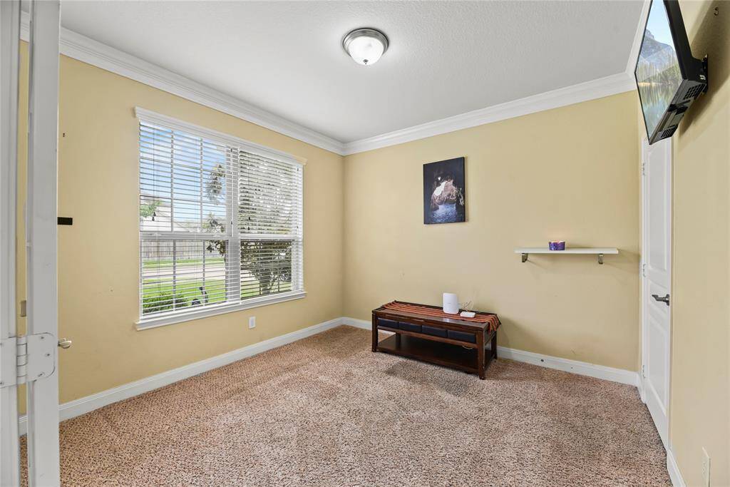 The home office is a refined and functional retreat, accessed through double glass doors that lend an airy, open feel while still offering privacy.
