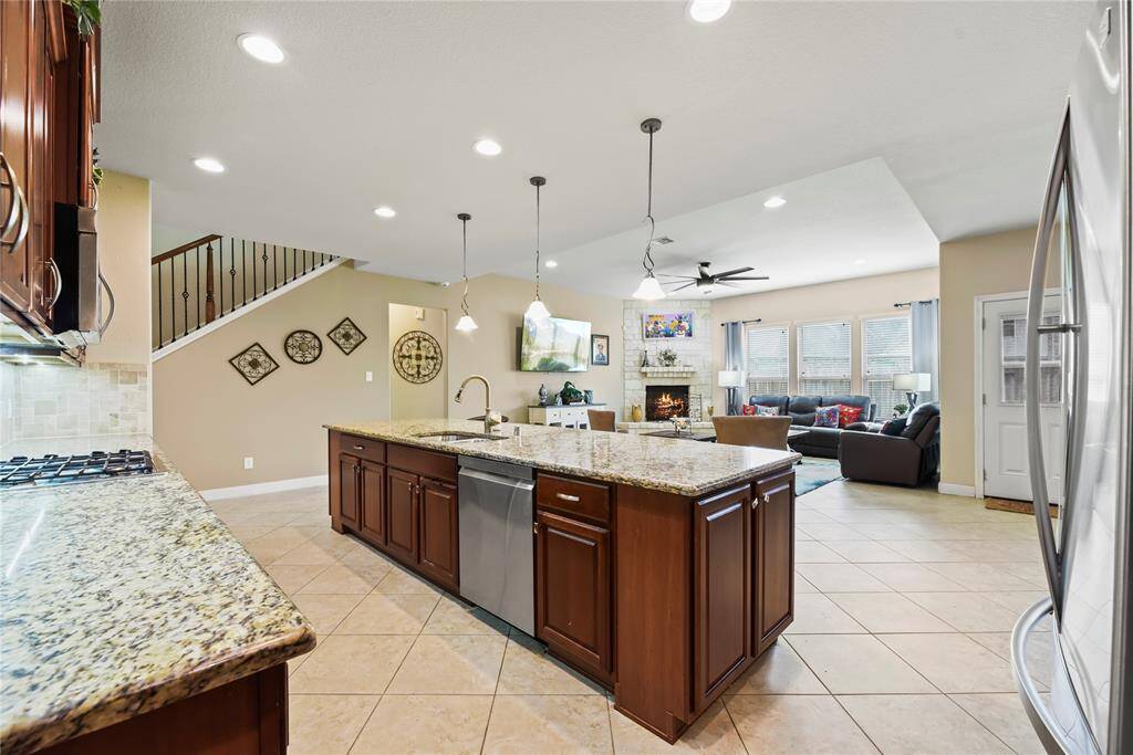 Granite countertops paired with a coordinating stone backsplash not only provide a durable and elegant surface for food preparation but also add a touch of luxury and sophistication to the kitchen.