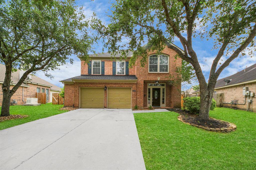 This home’s warm brick façade is framed by a well-kept lawn and mature trees. At the recessed front entry, the new door with sidelights and a transom window lend an elegant welcome.