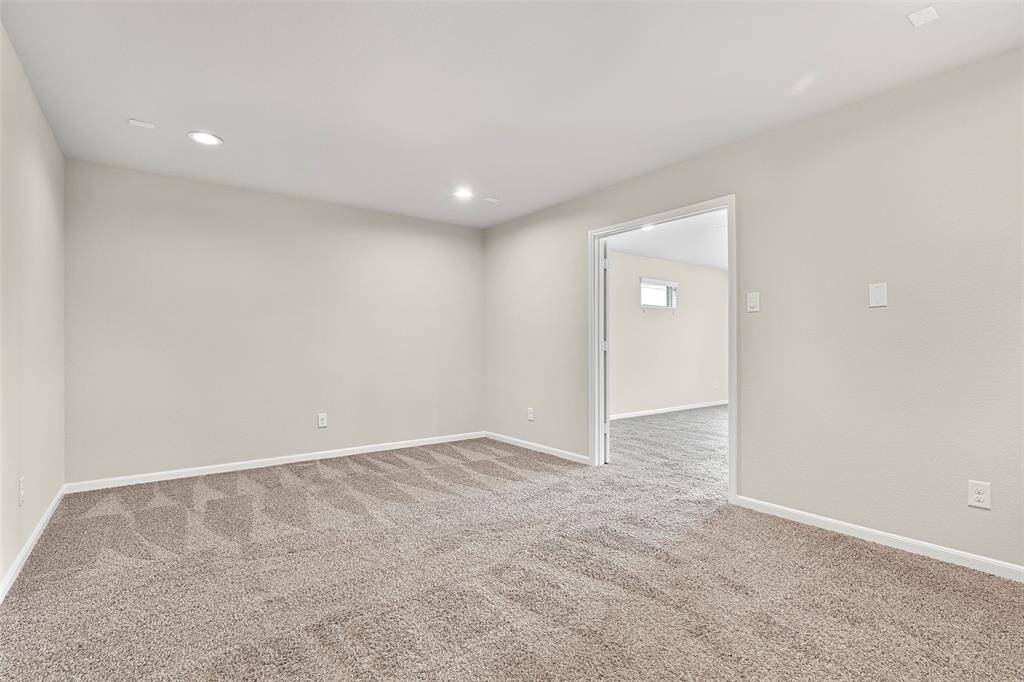 Dedicated media room with fresh paint and double-door entry from the gameroom—ideal for immersive movie nights, gaming, or a quiet retreat.