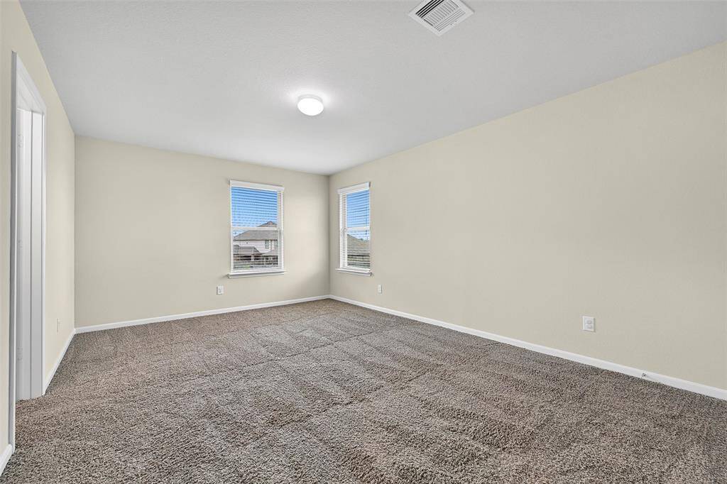 The fourth and final bedroom is located upstairs and offers a spacious layout with fresh paint, a large walk-in closet, and shared access to a Jack & Jill bathroom.