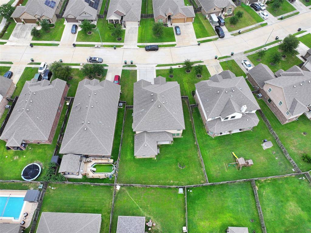 Aerial view showcases the generous backyard size and well-maintained lot, offering ample space for outdoor activities and potential future additions.
