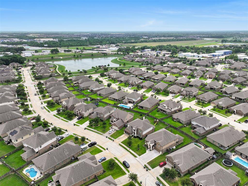 Aerial perspective highlights the inviting Bakers Landing community, featuring scenic walking trails, a serene community pond, and a nearby playground—perfect for outdoor enjoyment and family recreation.