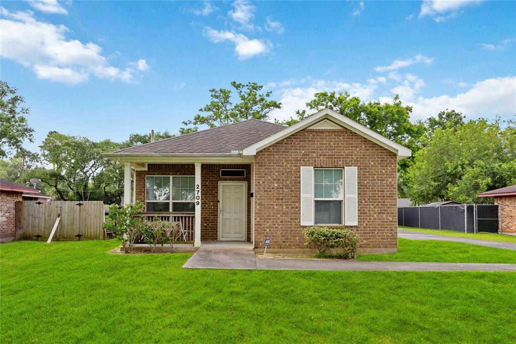 Charming brick home with a welcoming front porch, lush green lawn, on a quiet. Perfect for your next chapter.