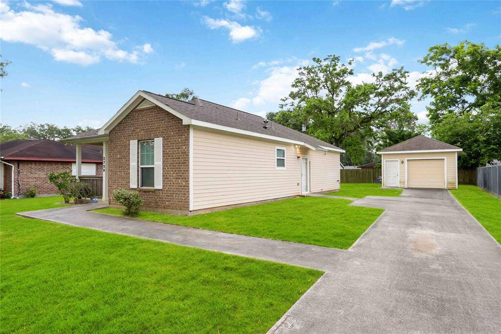 Enjoy the convenience of an extended driveway leading to a detached single-car garage.
