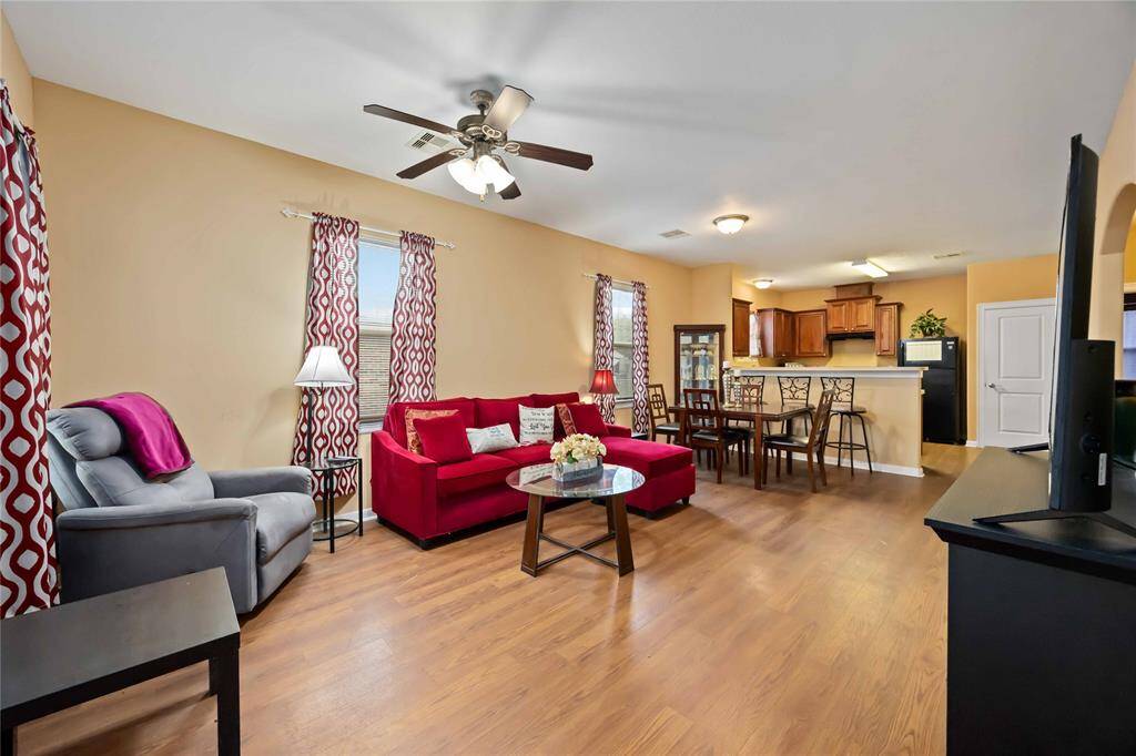 Cozy and inviting living room with an open layout, seamlessly connecting to the kitchen and dining area. Perfect for entertaining and family gatherings.