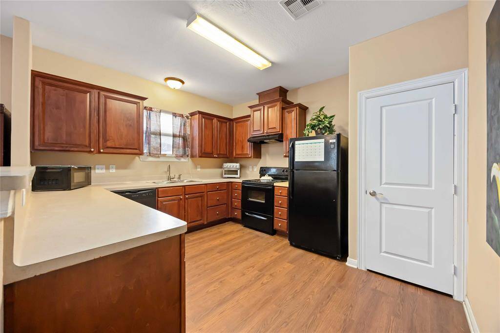 Another view of kitchen and pantry entry