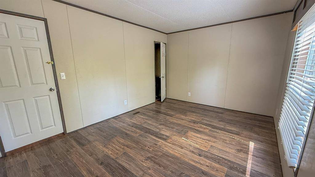 The second bedroom features a walk in closet and large window to help fill the space with natural light.