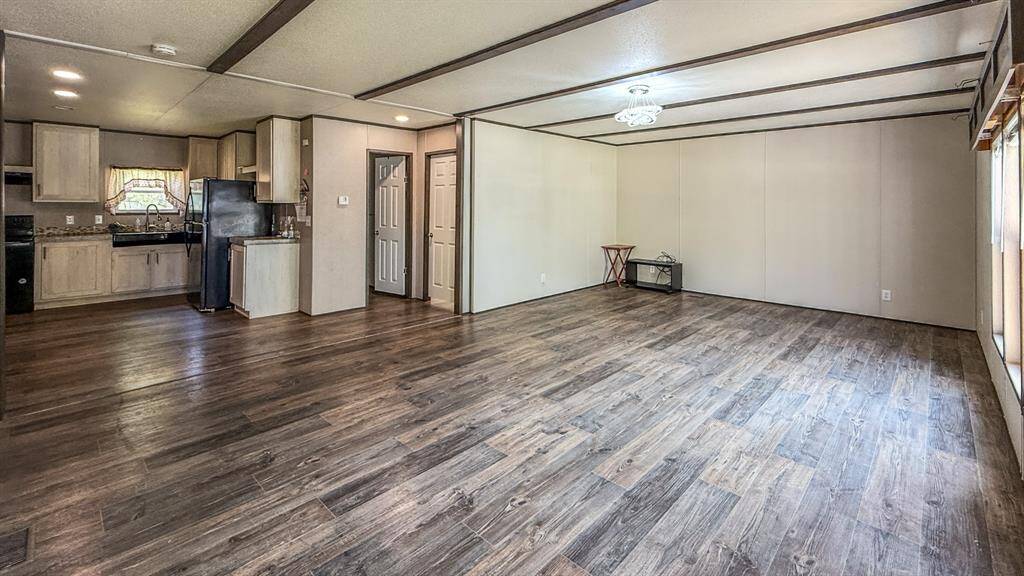 This spacious living area features an open concept design with large windows to allow natural light to fill the home.