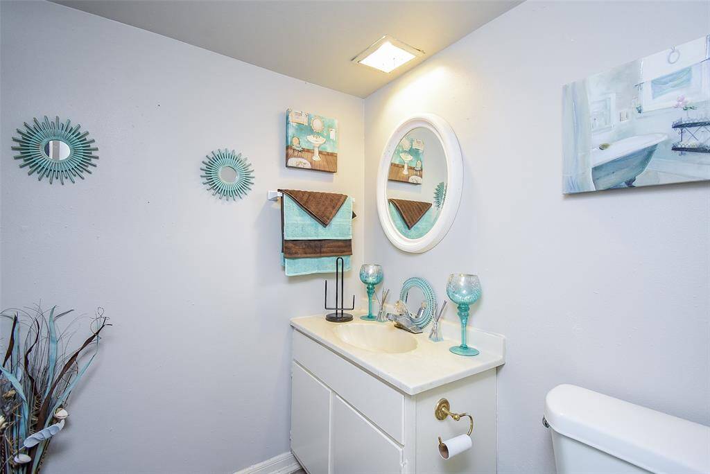 The half-bath is roomy and inviting, just off the main entrance hallway.