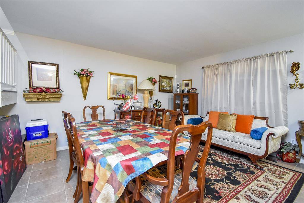 This area also receives great natural light from the curtained window on the right. It is a den used as a dining area.