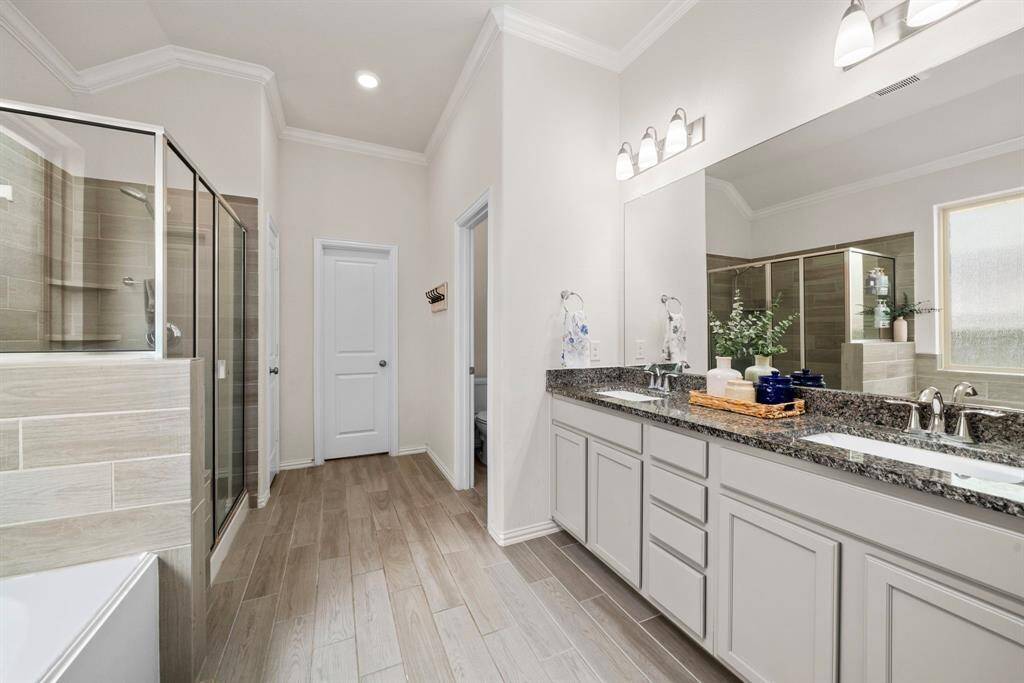 The primary bathroom includes double sinks and additional countertop space between.