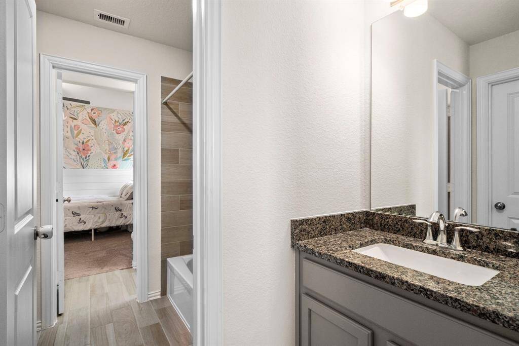 The Jack & Jill bathroom is located between bedrooms 3 & 4 and boasts 2 separate sinks.