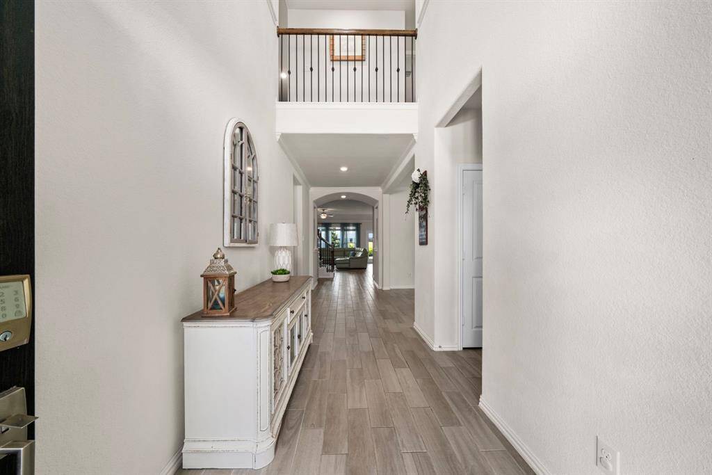 The foyer is grand with a 2 story ceiling and a galley style hallway, is great for artwork and creates a luxurious and welcoming entry.