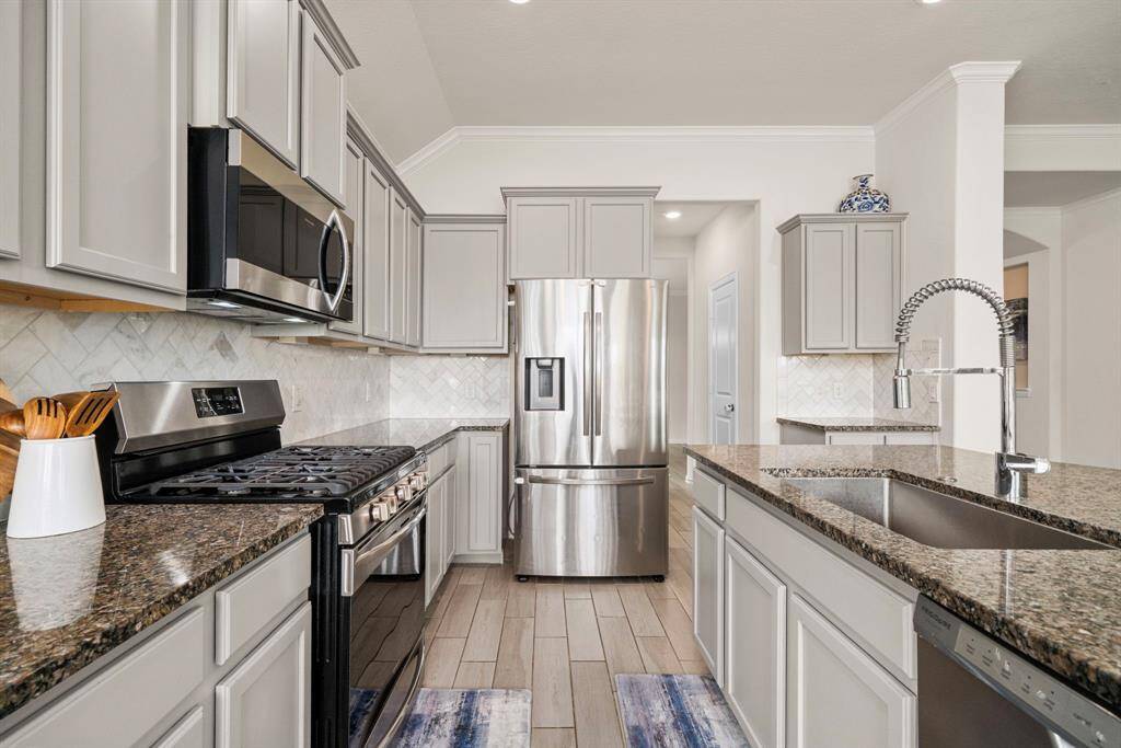 The kitchen has an abundance of cabinets and countertop space throughout