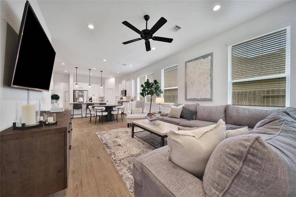 Large windows let in plenty of natural light and this space is large enough for comfortable furniture pieces where everyone in your family has a space to relax.