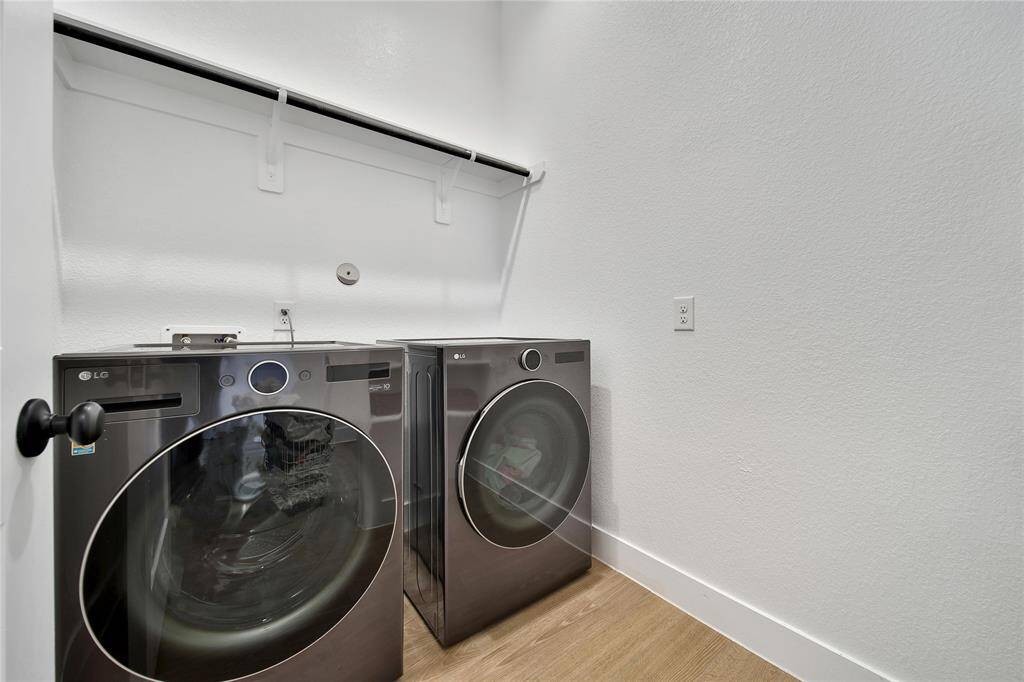 Interior laundry room with hanging space.