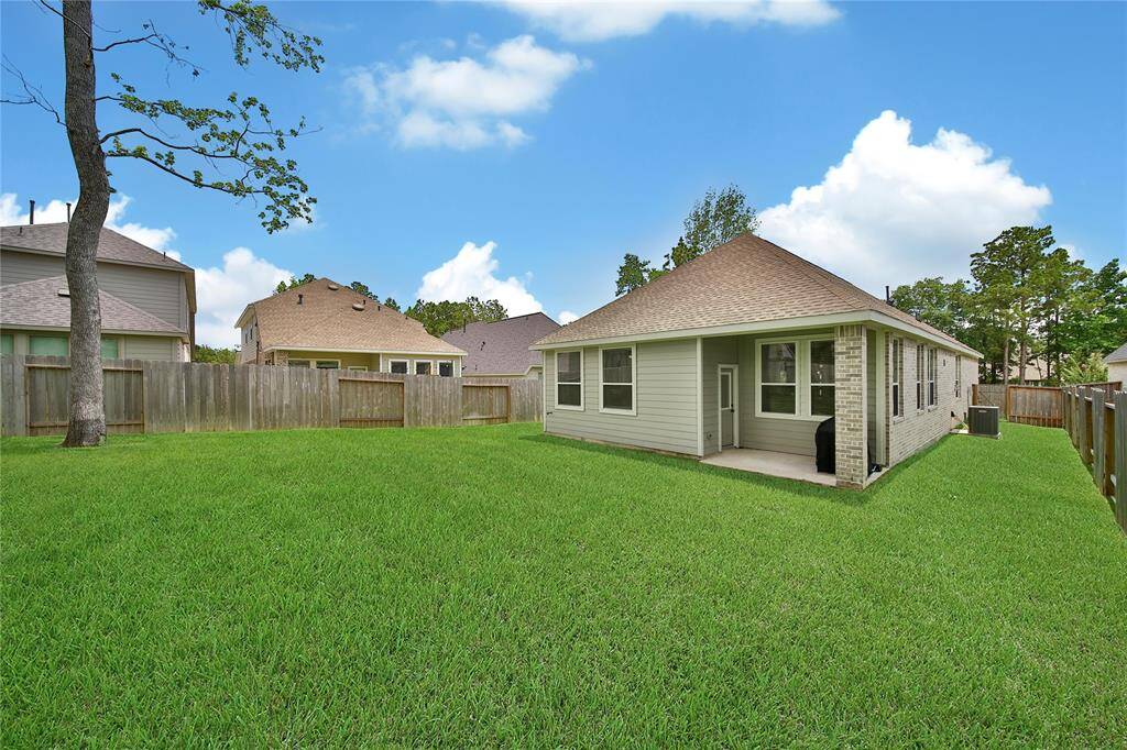 Cozy covered back porch and spacious fenced yard.