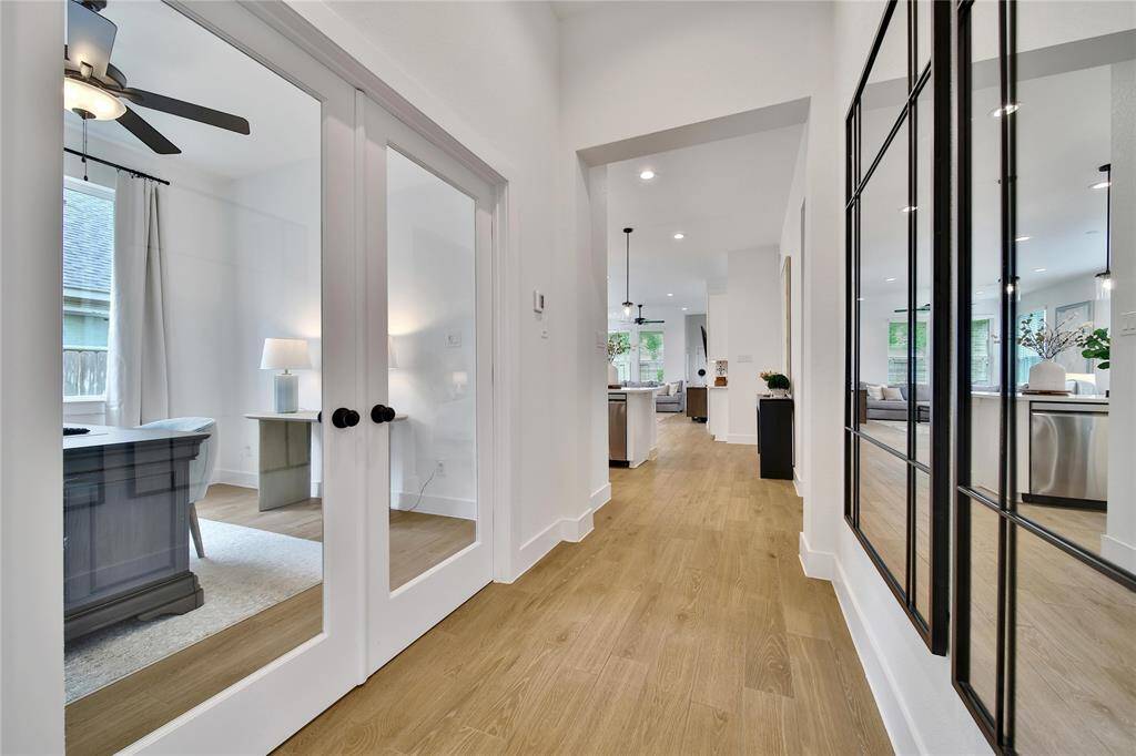 Step inside and appreciate the gorgeous wood-look tile floors and how light and bright this home feels with soaring 10-ft ceilings.