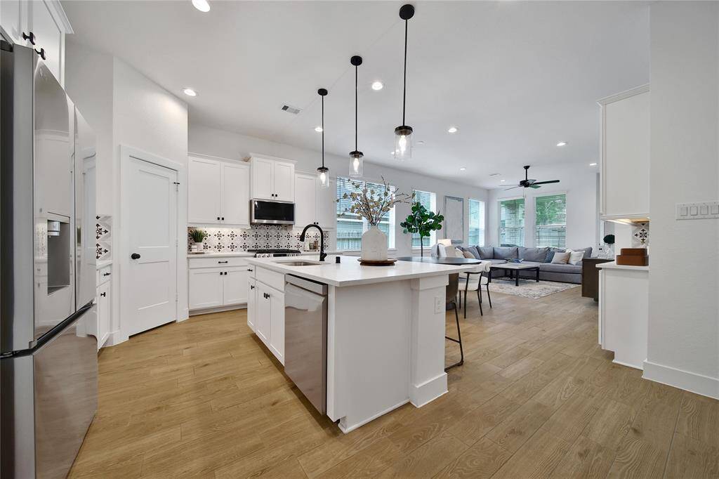 Enter into the heart of the home where you'll find the kitchen, dining area, and family room.