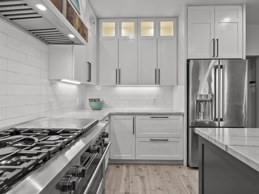 Fisher Paykel duel gas range and custom vent hood.
