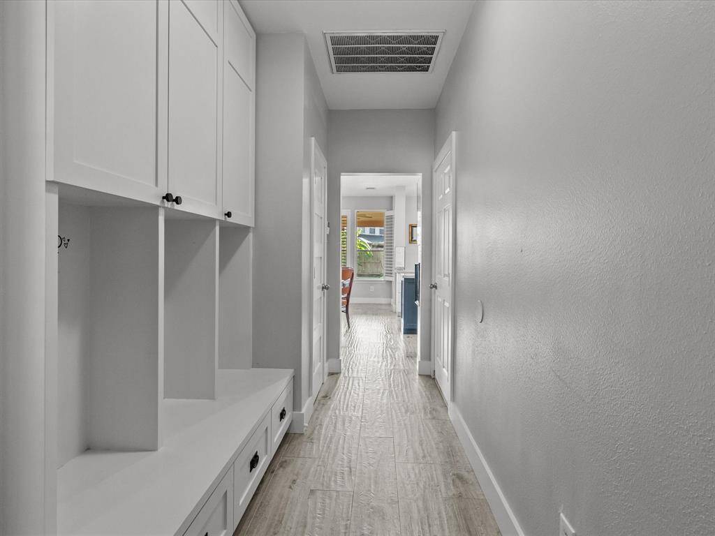 hallway to pantry, laundry, garage and formal dining with built in drop zone.