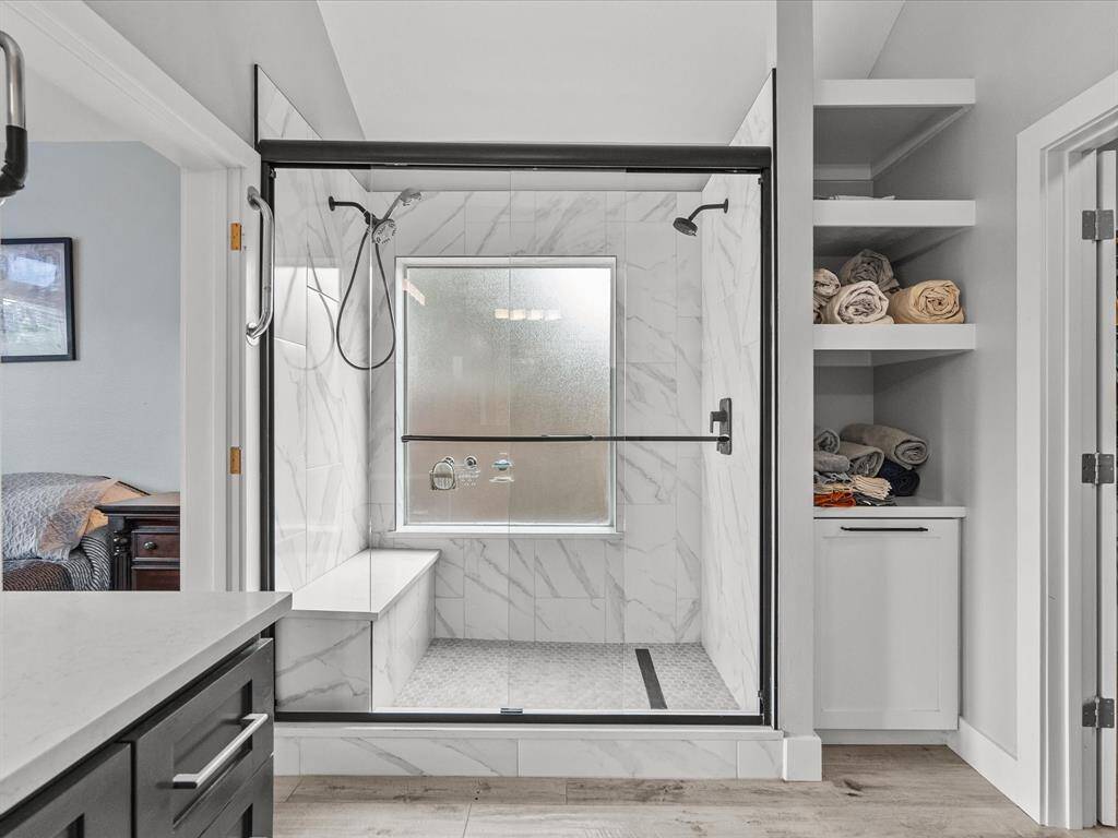 Totally remodeled primary bath with walk-in shower, dual shower heads, double vanities and massive walk-in closet.