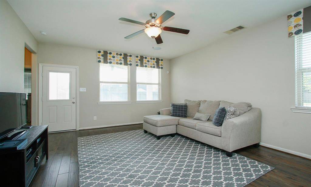 Down stairs den offers a great place for the kids to hang out.   Notice the wood floors.
