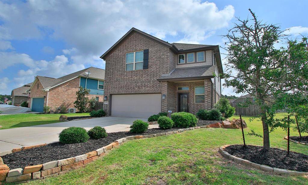Plentiful landscaping adorns the front of the home.