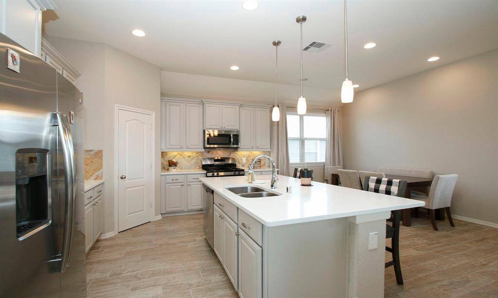 Large oversized island has upgraded granite with an undermount sink.   This island offer extra seating as will as extra counter space.