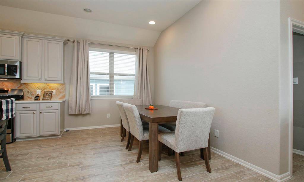 The kitchen opens up to the dinning area.   Notice the high ceilings.