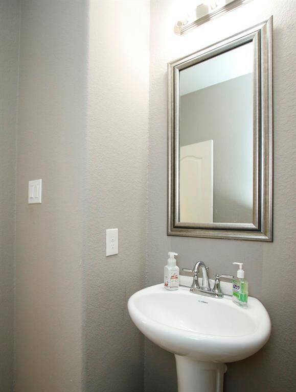 This half bath is conveniently located off the kitchen.