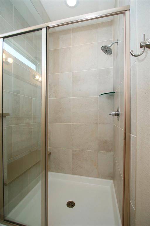 Nice walk in shower with floor to ceiling tile.