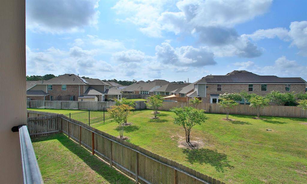 View from the upstairs balcony  over looking the green space next to the home.